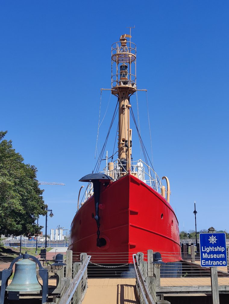 The bright red Portsmouth Lightship Museum under a blue sky in Portsmouth, Virginia